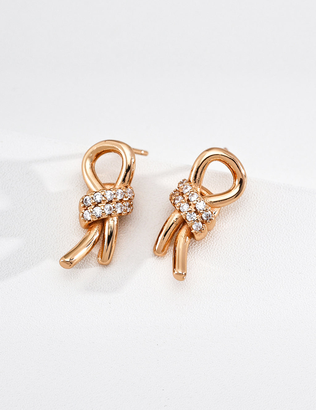 Knot Zircon Studs in Vintage Gold – front view